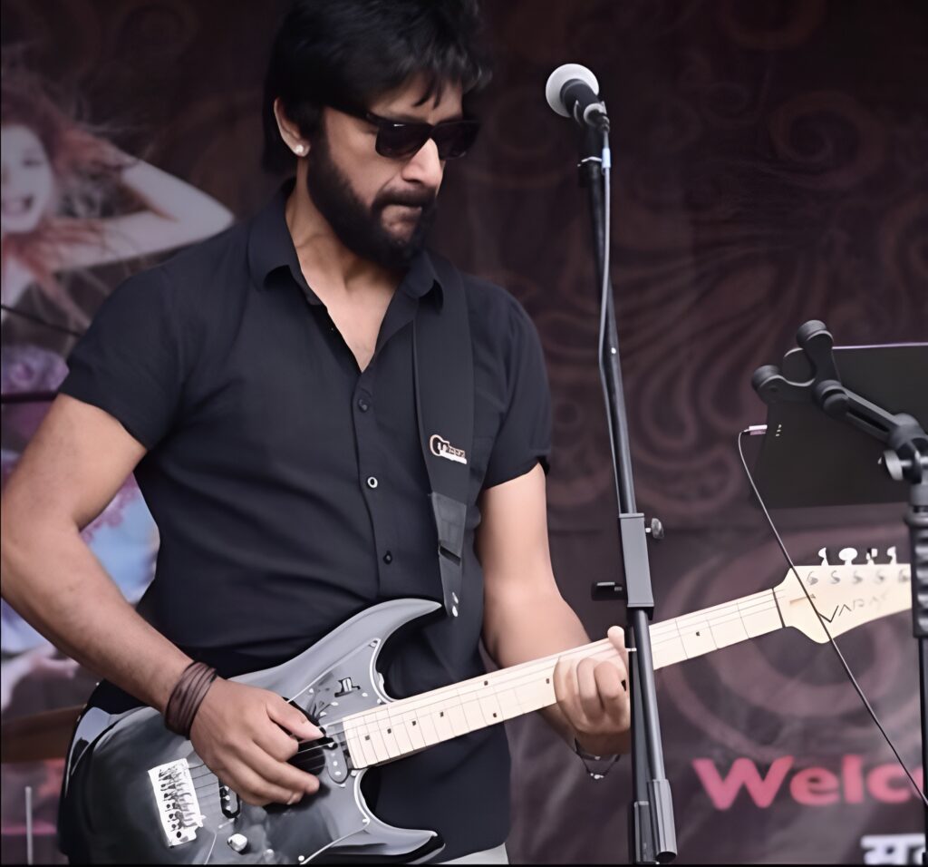 Male Bollywood Singer playing the Guitar on stage